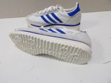 white and blue adidas sneakers on a white surface