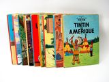 several children ' s books are lined up on a white surface