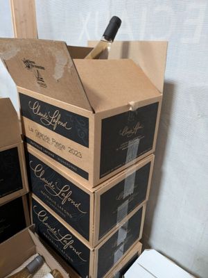 several boxes of wine are stacked on top of each other