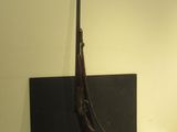 a gun on a table next to a book
