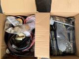 two cardboard boxes filled with assorted items sitting on top of a table