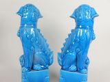 pair of blue ceramic foo foo dogs on pedestals with white background