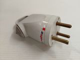 a white and gold plug on a white surface