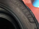 a close up of a tire on the ground next to a blue cup
