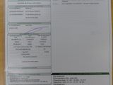 une photo d'un ticket de caisse posé sur un bureau, avec une calculatrice à côté