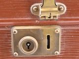 a close up of a brown suitcase with a lock on it