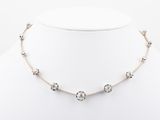 a white and silver necklace on a mannequin neck