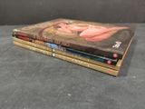 three books stacked on top of each other on a table
