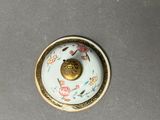 a small white and gold bowl on a table