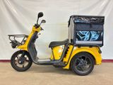a scooter that is parked in front of a white wall