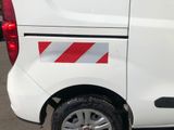 a white van with a red and white stripe on the side of it