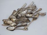 a lot of silver spoons and forks on the table