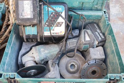 a green box with tools in it on the ground