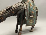 a statue of a horse with a saddle on it ' s back