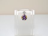 a small clear box with a pair of earrings in it
