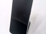 a cell phone that is on a stand on a table