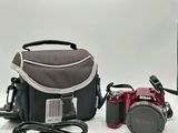 a camera, a camera case, and other electronics on a table