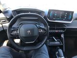 someone is sitting in the driver ' s seat of a car with their feet on the steering wheel