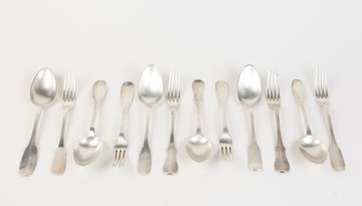 a lot of forks and spoons on a white table