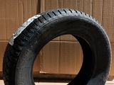 tires are stacked on a cardboard box in a room
