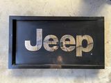 black and white jeep sign hanging on the side of a wall