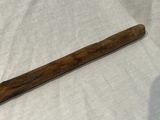 a baseball bat that is laying on a white sheet