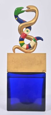 a sculpture of a snake sitting on top of a blue container