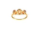 a close up of a gold ring with an orange stone