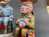 two figurines of two men sitting on a bench