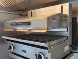 two grills that are sitting in the middle of a kitchen