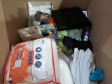 a cardboard box filled with many items and a stuffed animal