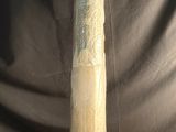 a baseball bat sitting on a table in front of a curtain