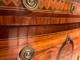 a wooden dresser with a marble top and brass knobs