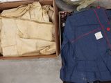 a box full of clothes and other items on the floor