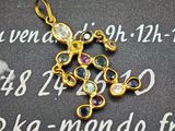 une croix en or ornée de pierres multicolores