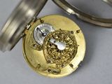 a close up of a pocket watch with a keychain