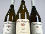 three bottles of wine sitting on top of a table next to each other