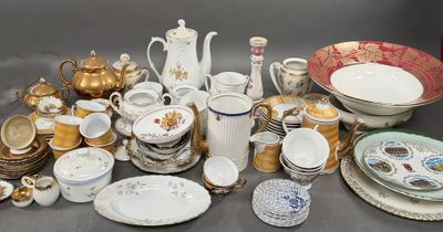 many different types of dishes and cups on the table