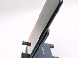 a phone that is sitting on a stand on a table