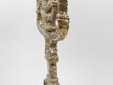 an image of a sculpture of a vase on a wooden base