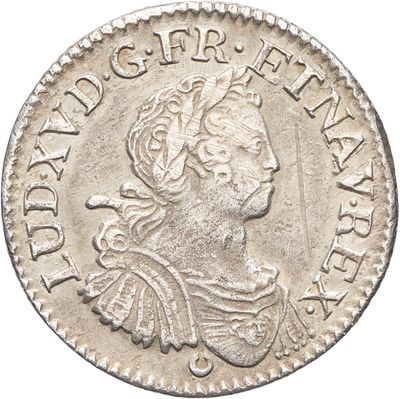 une pièce d'argent sur laquelle figure l'effigie d'une femme coiffée d'une couronne