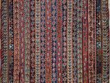 a red and blue rug with a pattern on it
