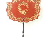 a red fan with a gold design on it