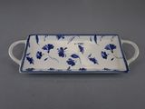 a blue and white serving tray with flowers on it