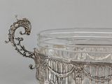 a glass bowl with a handle on a table