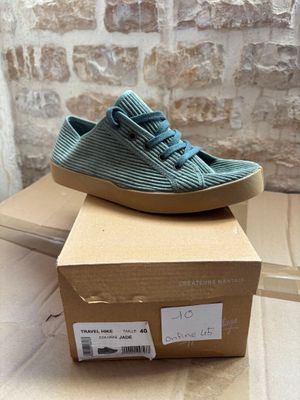 nike tennis shoes in a box on a table next to a brick wall