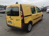 a yellow van that is parked in a parking lot