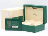 rolex watch in a green box with a card in it