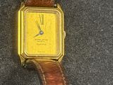 an image of a yellow watch sitting on top of a brown leather strap