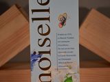 a box of toothpaste sitting on top of a wooden table
